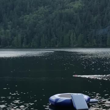 Guy surfboard lake paddling