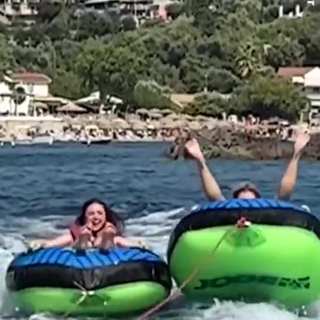 Alan Carr tumbles off inflatable 'doughnut' ring on Greece getaway