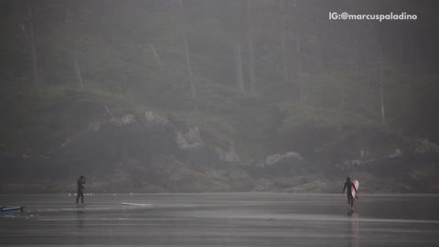 Wetsuit guy with surfboard shadow boxes on beach