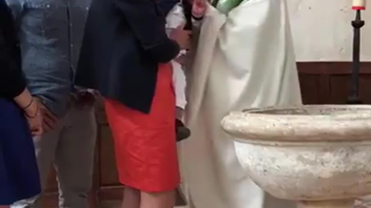 Priest slaps baby for crying during baptism