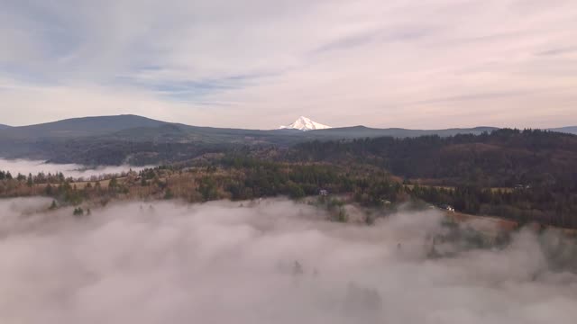 Beautiful Foggy Mountain with the white clouds forming around