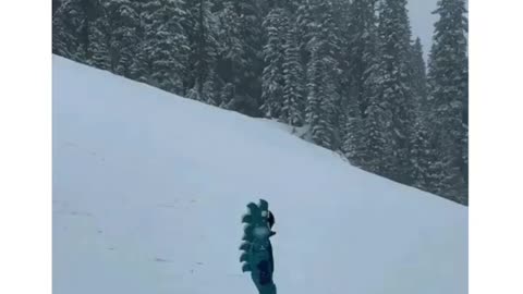 Toddler talks to herself while snowboarding