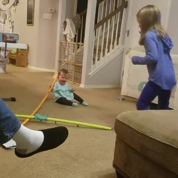 Big sister makes baby laugh with crazy toy.