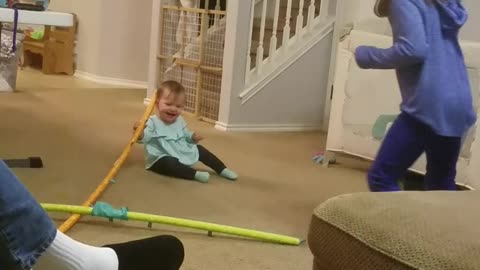 Big sister makes baby laugh with crazy toy.