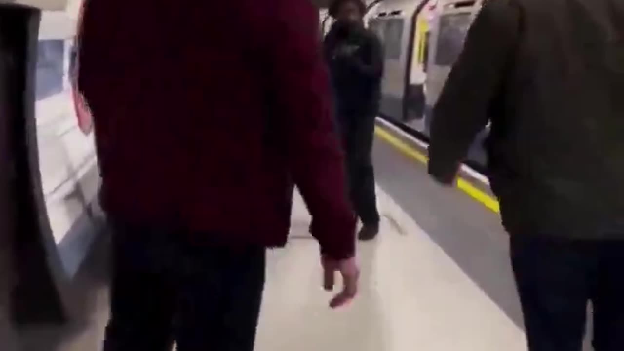 Man whips random Woman with cord in London Underground