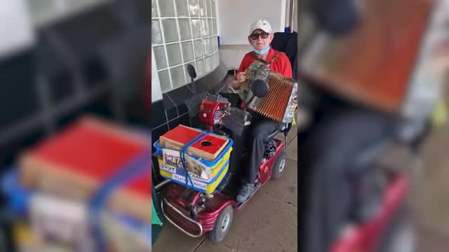 Thomas O'Halloran plays accordian and chats to locals in Greenford