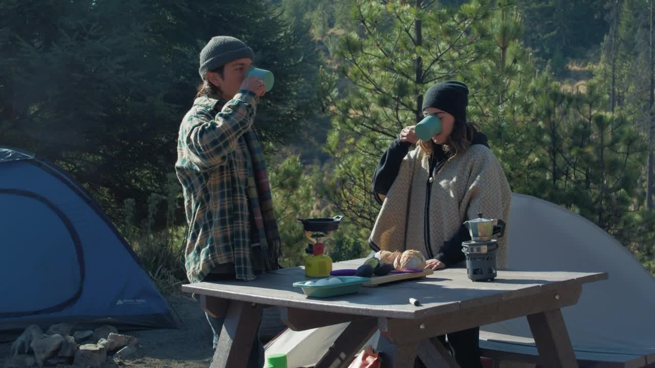 Couple having coffee in a campsite