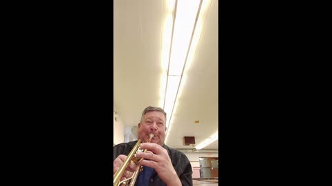 Checking out an old trumpet found in a school closet.