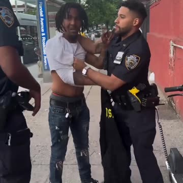 Cop watches as man fights his partner