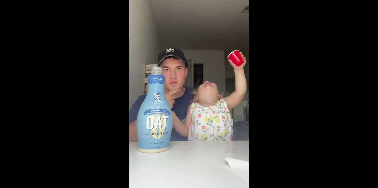 Hard drinking: Funny uncle and his toddler niece are taking shots of oatmilk
