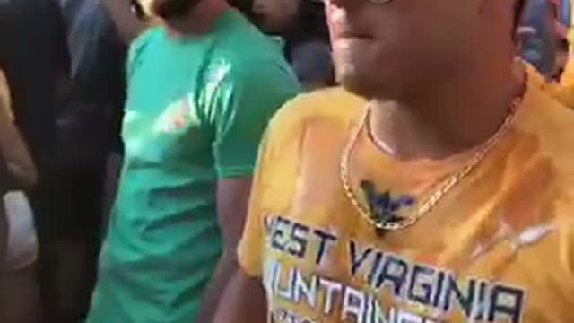 Guy in yellow shirt cracks beer on a girls head then chugs it