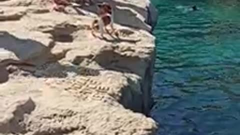 Man flying water with baby dog