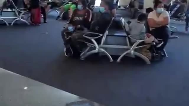Airport loaded with immigrants that all have colored envelopes
