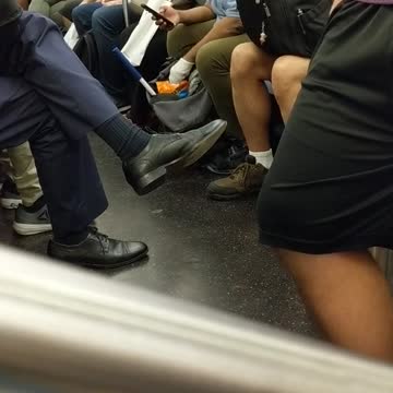 Woman on phone eating cheetos with white gloves subway