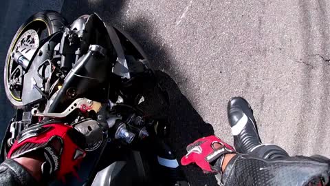 Motorcycle Rider Slides Along the Street After Attempted Wheelie