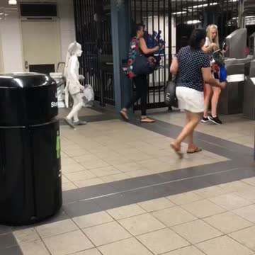 Small person kid dressed in all white subway station