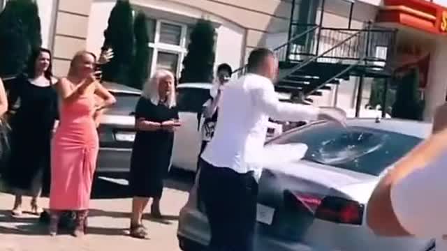 Funny scene of foreign wedding repairing car.