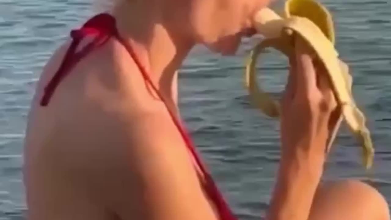 I wonder what this lady is thinking while she eats a banana?