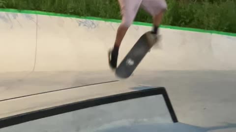 Skateboarding Ollie over Bar and Heel-flip