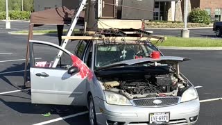 Parking Lot Musician Performs on Top of Car