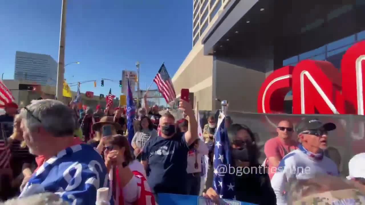 Protestors chant CNN sucks in front of their building