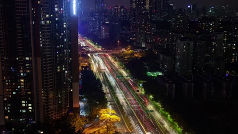 Large avenue that crosses a giant city at night