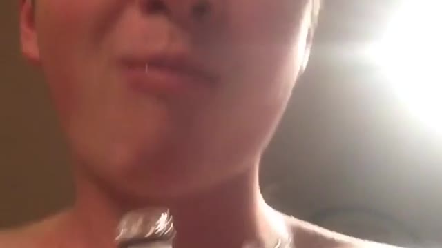 Guy taking shot in front of mom