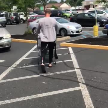 Guy coming out of grocery store with black wet suit