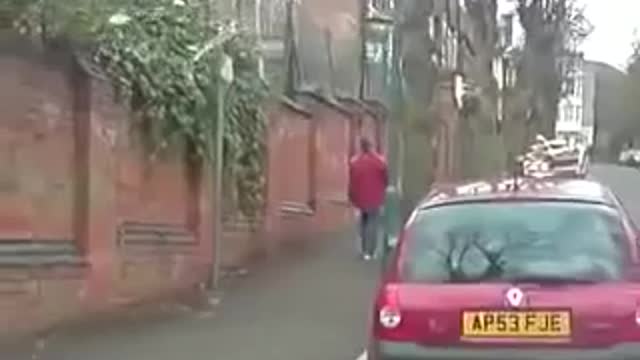 Drunk man tries to walk up street