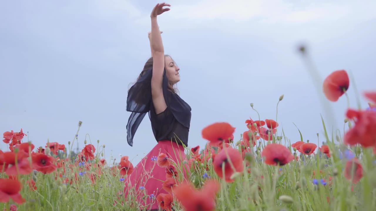 girl-dancing-happily-in-a-field-of-flowers-4k