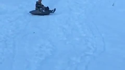 Guy tarp sled spins out laugh