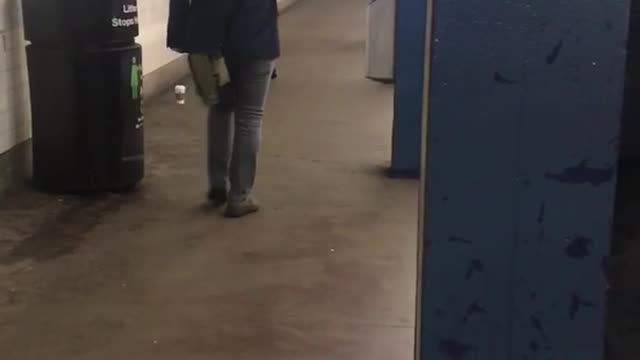 Guy blue shirt black satchel practicing fighting subway platform