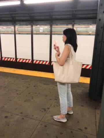 Woman in white subway pink water spray face fan