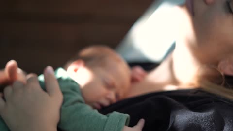 Baby sleeping on mothere's chest