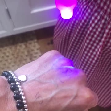 Mother and Daughter Test Blacklight on Mother’s Vaccine Jab.