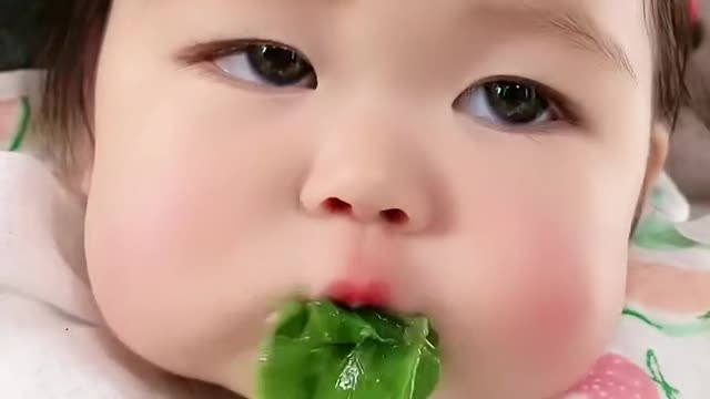 Very cute baby eating vegetables