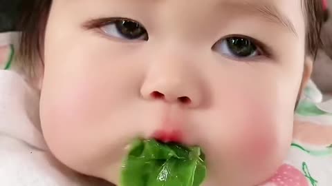 Very cute baby eating vegetables