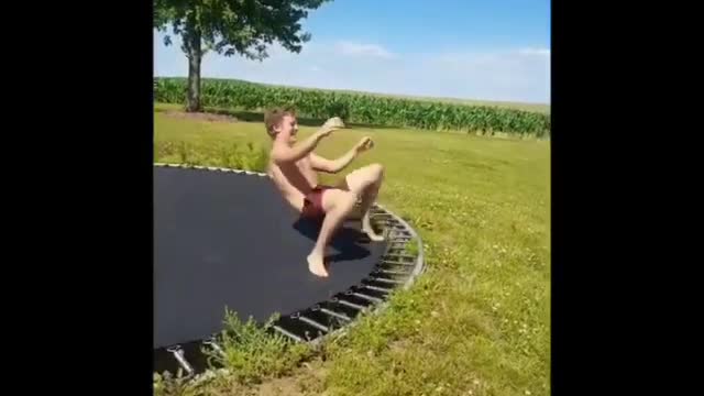 Guy in red shorts fails at trampoline flip