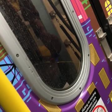 Guy peeing between moving train on subway train