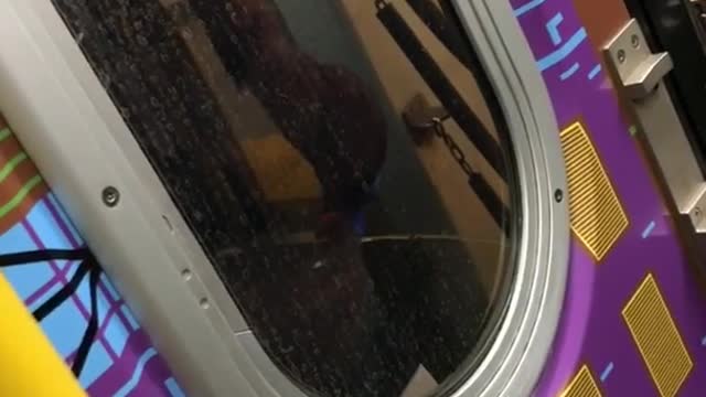 Guy peeing between moving train on subway train