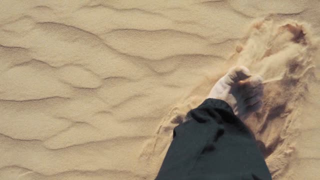 Man Walking Barefoot On Desert Sand