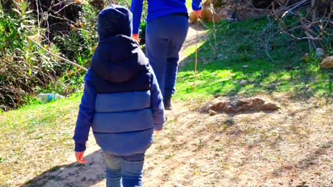 Anis and Hamza are hiking in nature with a waterfall