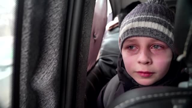 'We left our Dad in Kyiv' -little boy chokes back tears