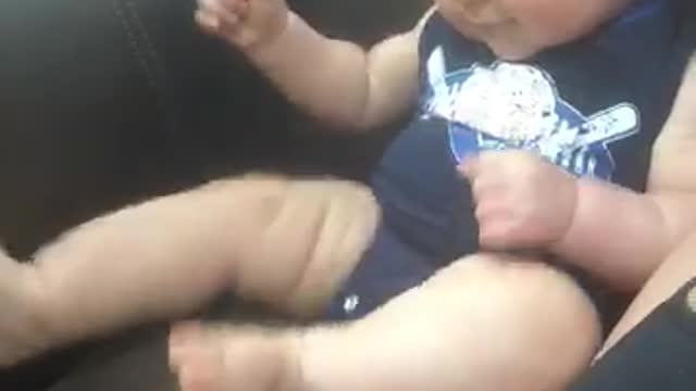 Playful baby suddenly put in trance by TV show