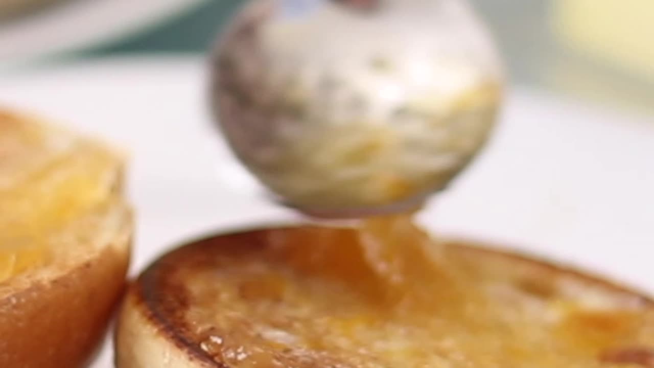 Spreading butter and jam on toasted pandesal