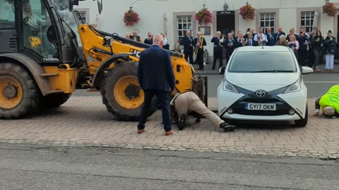 Locals Take Matters Into Their Own Hands When Parked Car Interrupts Festival