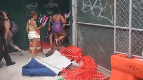 Public trample on man carpet