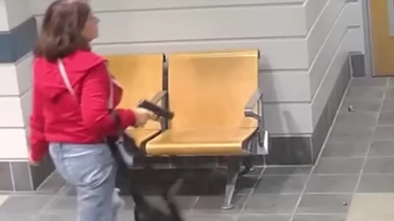 A woman opened fire inside police station before getting tased by police.