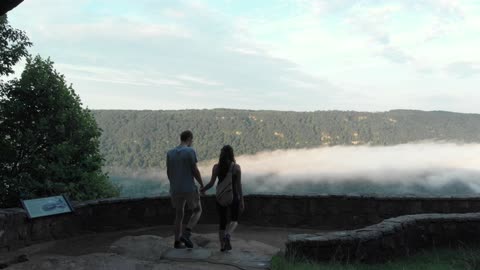 Couple Overlooking The View Of A Beautiful Landscape