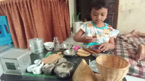 Playing mini cook set with clay